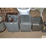 Three graduated galvanised containers