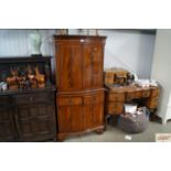 A reproduction mahogany drinks cabinet fitted two drawers and brushing side