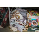A box containing various curtains etc