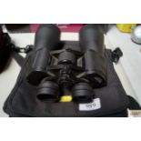 A pair of binoculars with carry bag