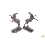 A pair of bronze boxing hare figures, 31cm high