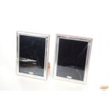 A pair of modern silver photograph frames with bea