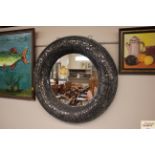 A decorative circular wall mirror, having crackled