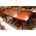 A cherry wood draw leaf extending dining table rai