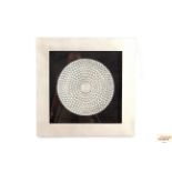 A circular embossed wall art plaque in silvered fr