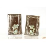 A pair of mirrored wall mounting posy vases