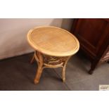 A rattan and bamboo circular two tier occasional t