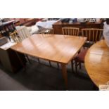 A 1970's teak extending dining table with integral