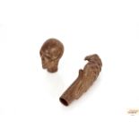 A bronze skull walking stick handle; and another i