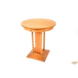 A pine circular centre table raised on column supp