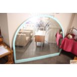 A large arched Art Deco mirror having line decorat