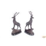 A pair of bronze stags, 44cm high