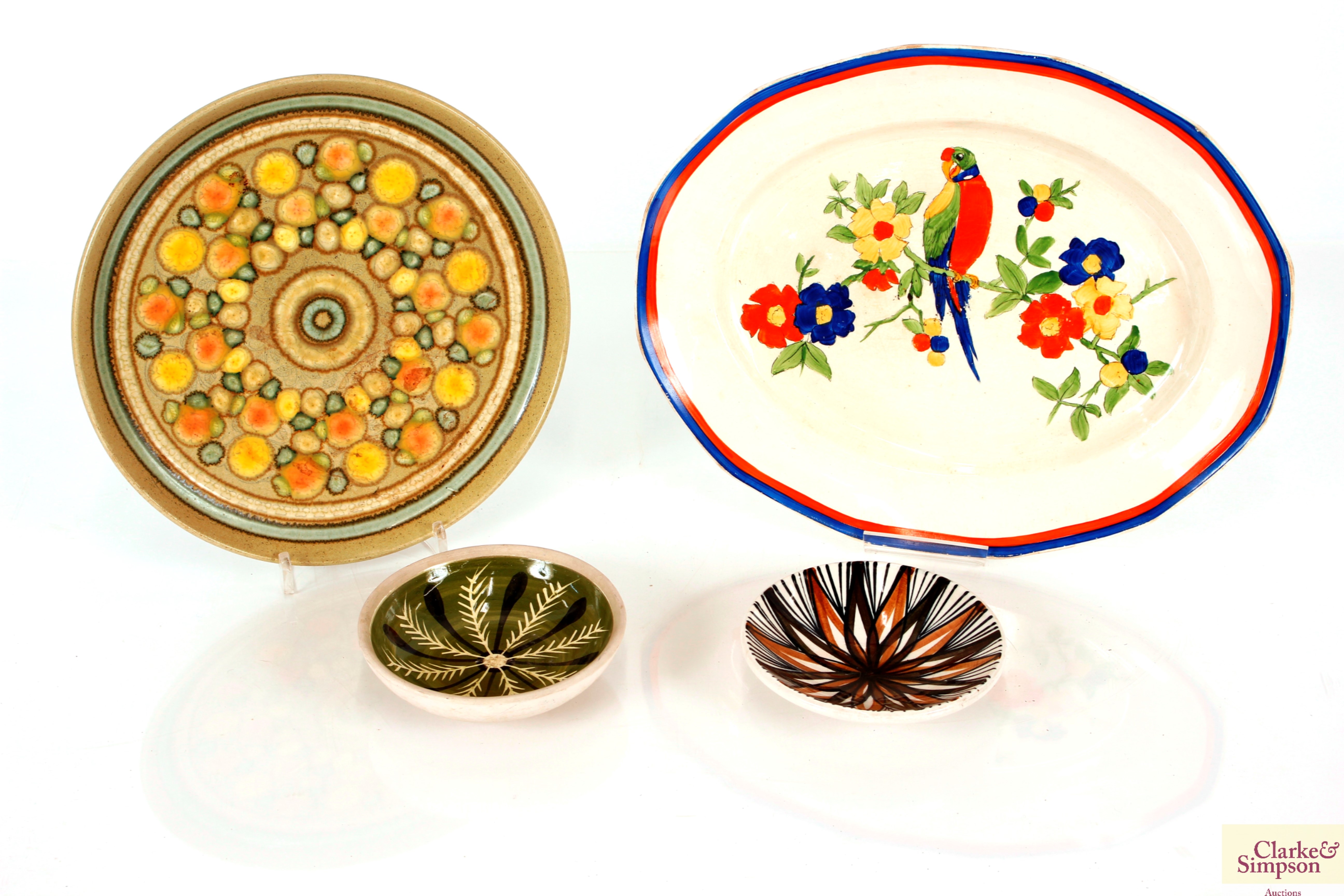 A Tripoli ware parrot decorated platter; a pair of