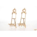 A pair of ornate brass easels, 41cm high