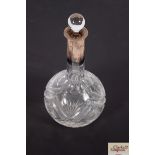 A cut glass and silver mounted decanter, 27cm high