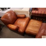 A brown leather deep seated east chair and matchin