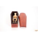 A small model of a skeleton in a wooden coffin 12.
