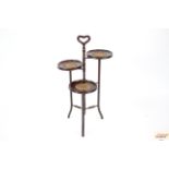 A mahogany three tier graduated cake stand with in