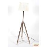 A modern metal ware tripod standard lamp and shade