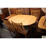 A light Ercol extending dining table 98cm x 140cm;