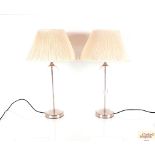 A pair of glass baluster table lamps and shades