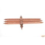 An unusual wooden calendar of arrow shape, 75cm l