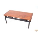 A teak G-plan coffee table on ebonised rounded sup