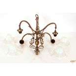 An Art Nouveau chandelier with four Vaseline glass