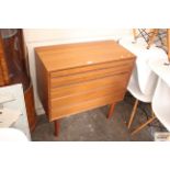 A teak G-plan style chest of four drawers raised o