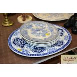 An oval blue and white meat plate and various other blue and white plates