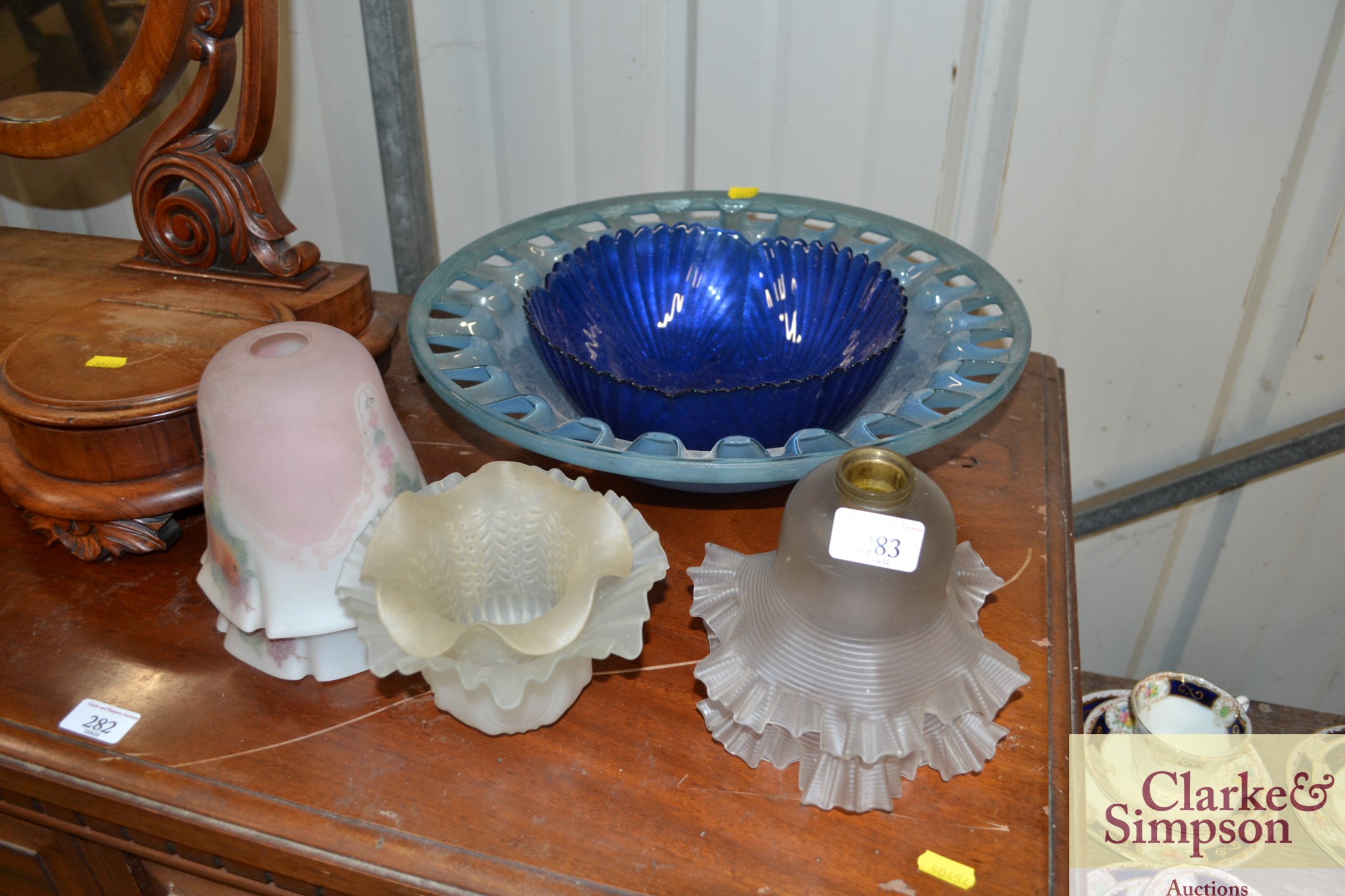A blue glass bowl; glass lightshades etc.