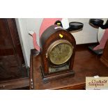 An oak cased two hole mantel clock