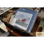 A box containing various pencil signed prints by Anthony Osler depicting ships