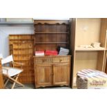 An oak dresser raised on cupboard base fitted two