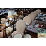 Six white upholstered dining chairs with covers