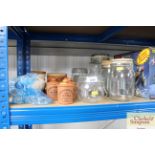A quantity of glass storage jars; and a quantity o