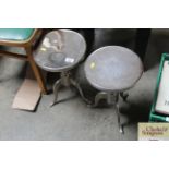 A pair of small circular topped tables