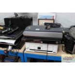 An HP printer/scanner; a Samsung 1080i DVD player; an Epson printer/scanner and an Epson scanner,