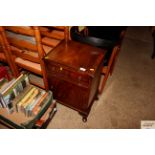 A mahogany bedside cabinet fitted single drawer and brushi