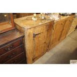 A late 19th Century stripped pine cupboard