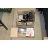 A box containing camera cases, camera manuals etc.