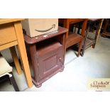 A stained pine bedside cabinet