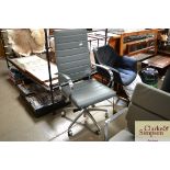 A grey upholstered swivel office chair