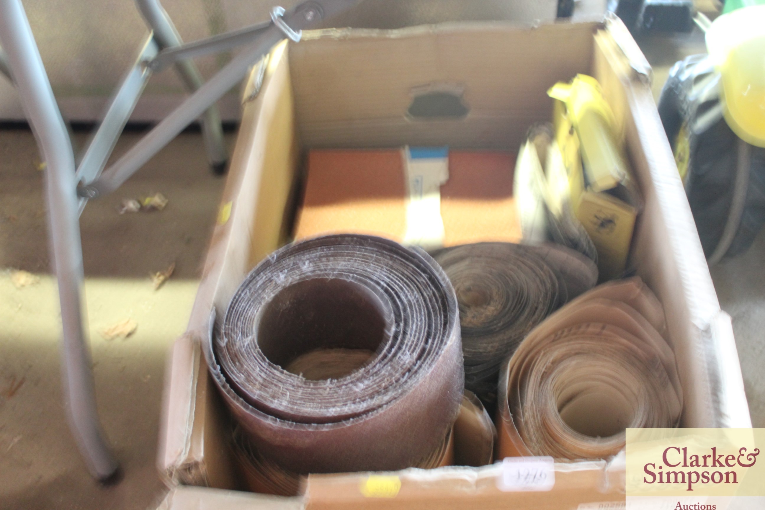 A box containing various rolls of sandpaper