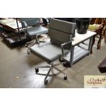 A grey upholstered swivel office chair