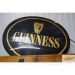 An illuminating Guinness advertising sign