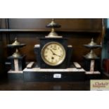 An Art Deco black slate and marble clock with garn