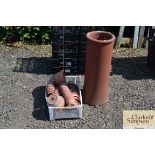A chimney pot and a box of terracotta flower pots