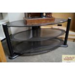 A black glass three tier tv stand