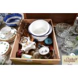 A wooden box containing various tins, mantel clock